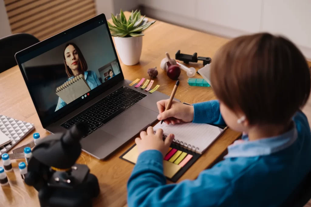 A preteen boy using a laptop for an online tutoring session, showing how online tutoring benefits different learning styles through one-on-one video support.