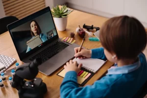 Educational Resources Blog 44 A preteen boy using a laptop for an online tutoring session, showing how online tutoring benefits different learning styles through one-on-one video support.